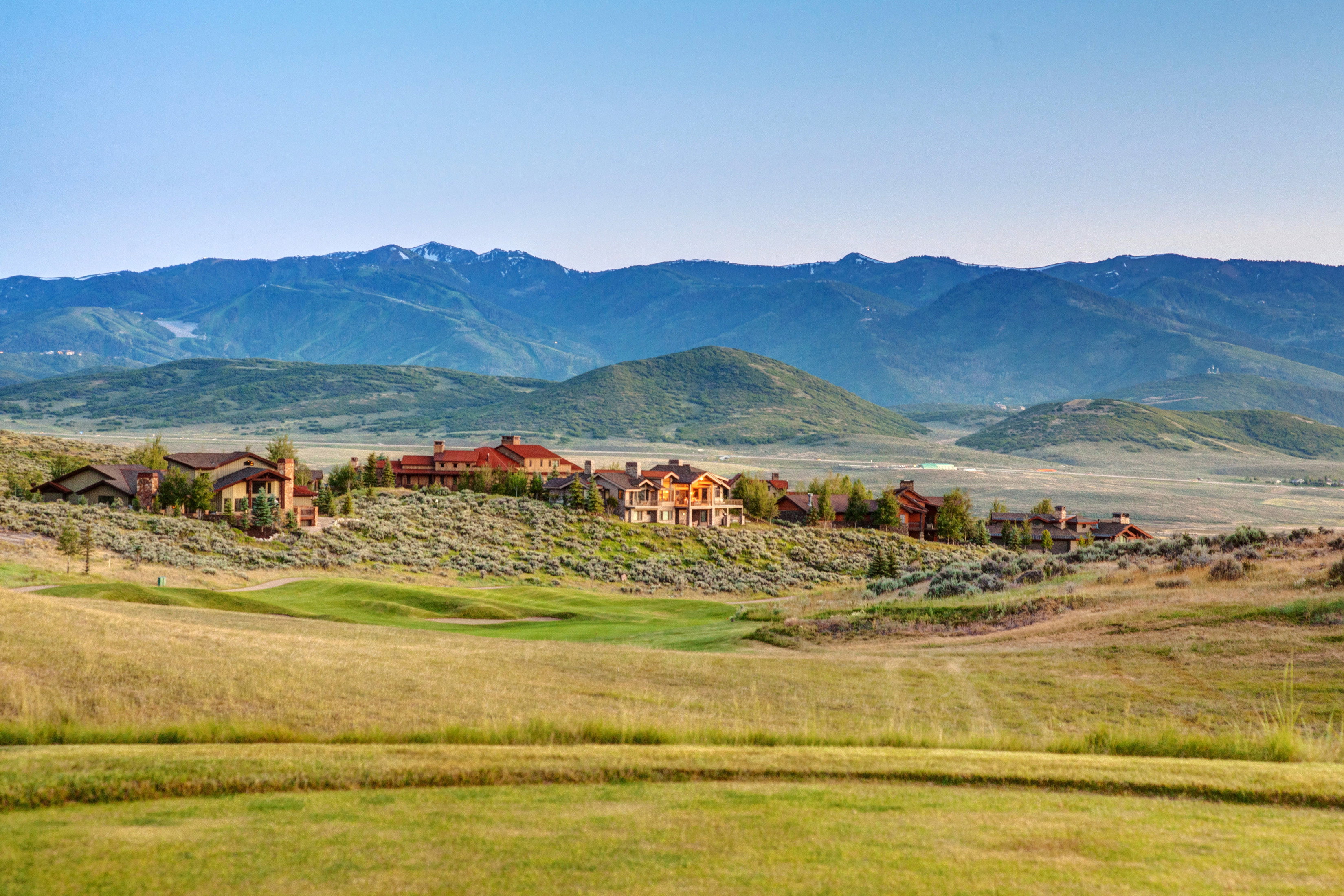 Expansive mountain scenery framing a collection of residences