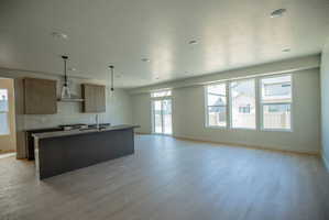 Open-concept living space with light wood-finish flooring