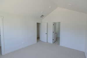Spacious room with vaulted ceilings and recessed lighting