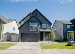 Contemporary two-story residence featuring a dark gray exterior finish and a two-car garage