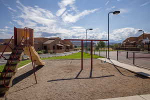 Playground area featuring a slide, swing set, and sand base