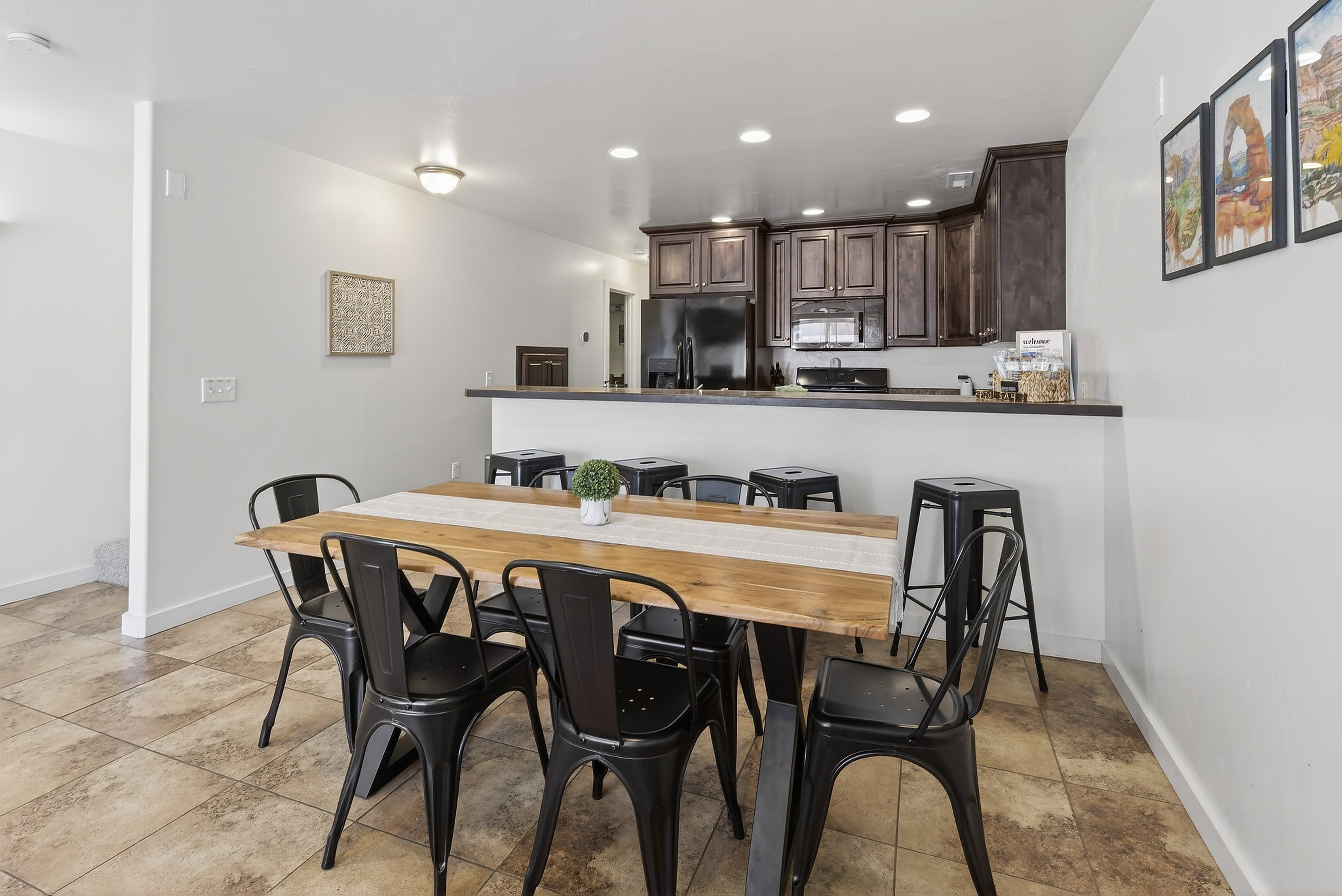 Open-concept living space featuring ceramic tile flooring and a breakfast bar