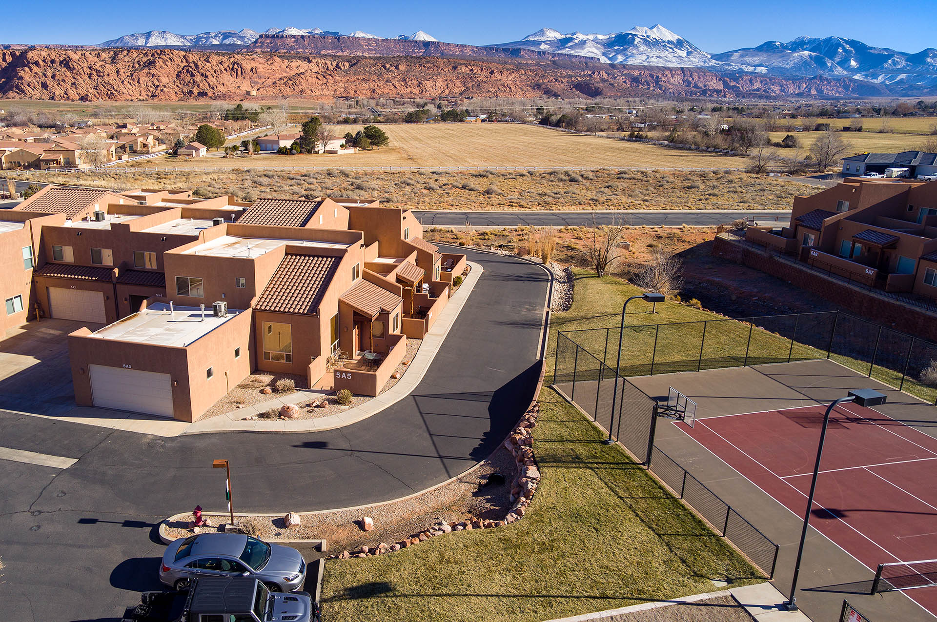 Townhome complex featuring stucco exteriors and attached garages