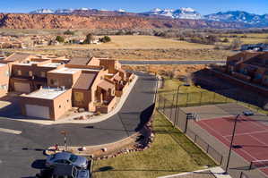 Townhome complex featuring stucco exteriors and attached garages
