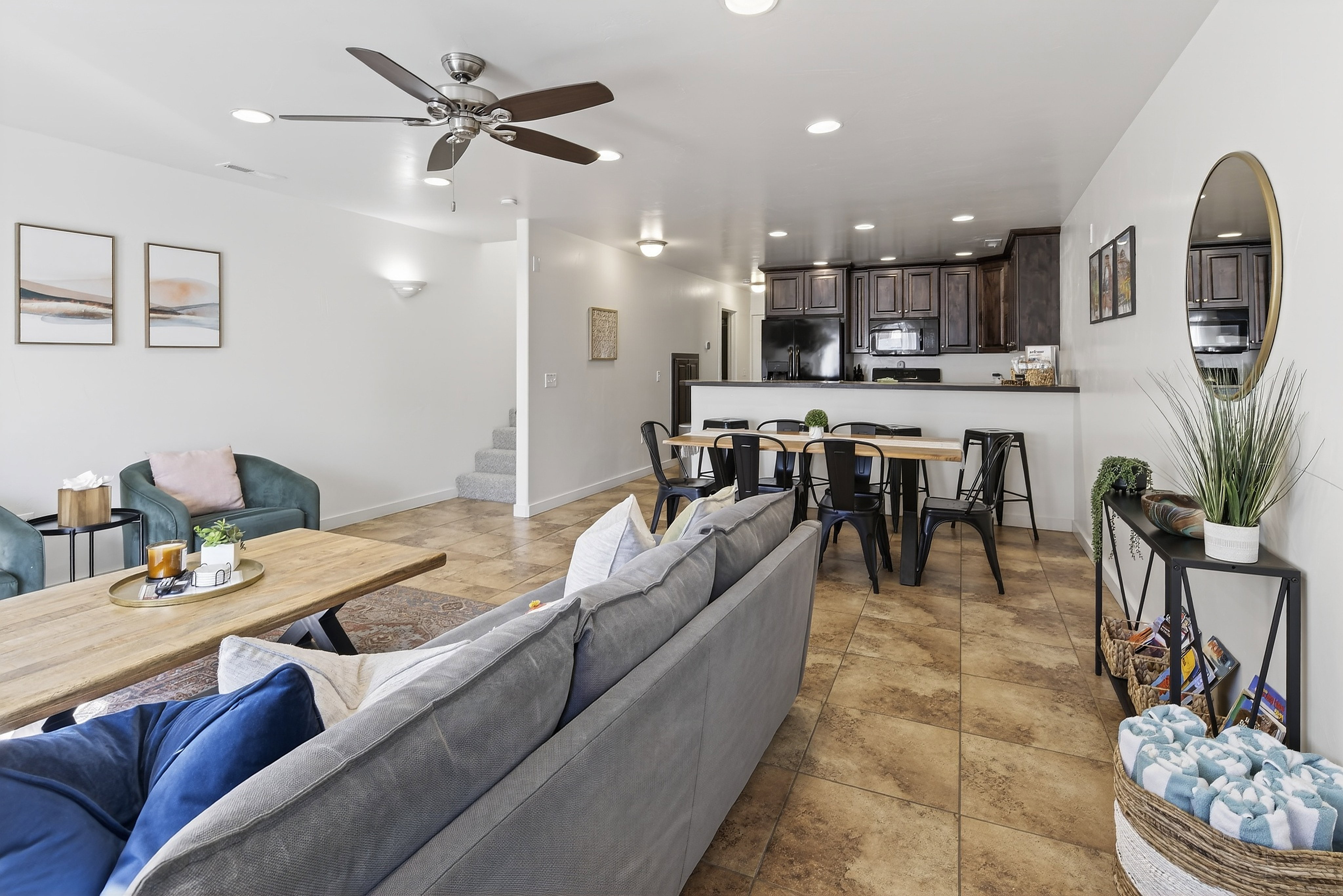 Open-concept living space featuring ceramic tile flooring and recessed lighting