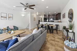 Open-concept living space featuring ceramic tile flooring and recessed lighting