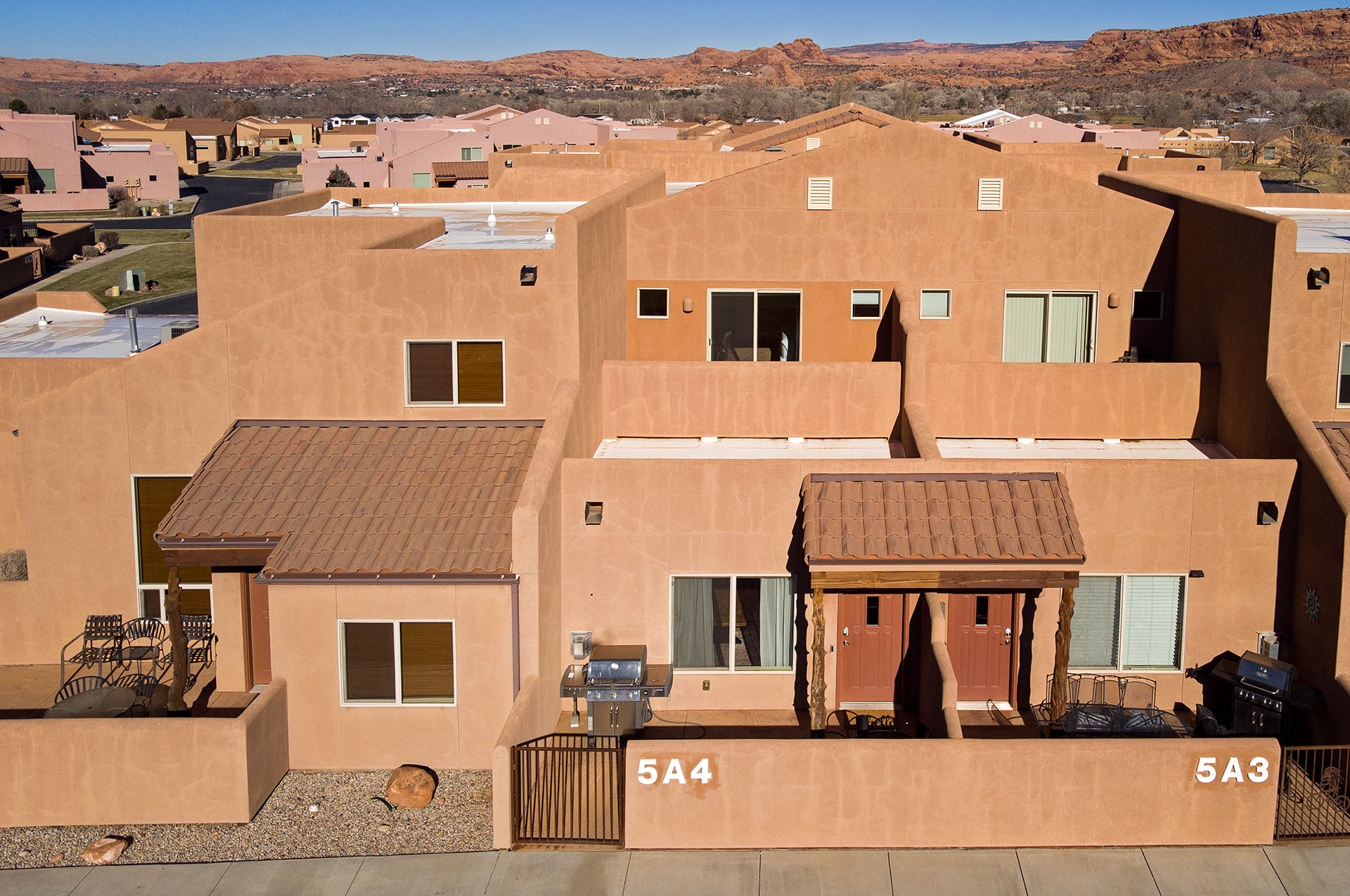 Southwestern-style stucco exterior with flat and sloped roofs