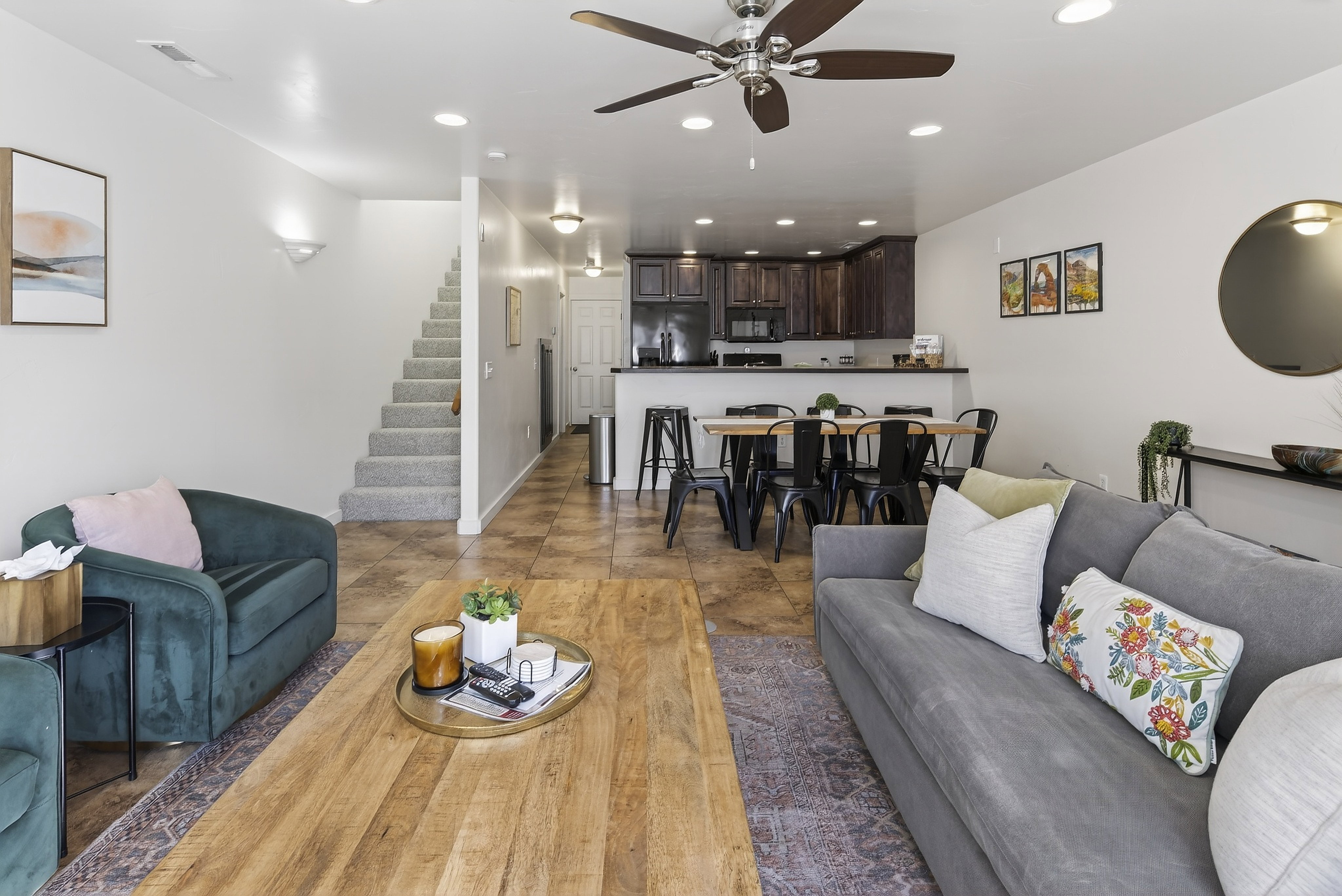 Open-concept living space featuring wood-finish flooring, recessed lighting, and a ceiling fan