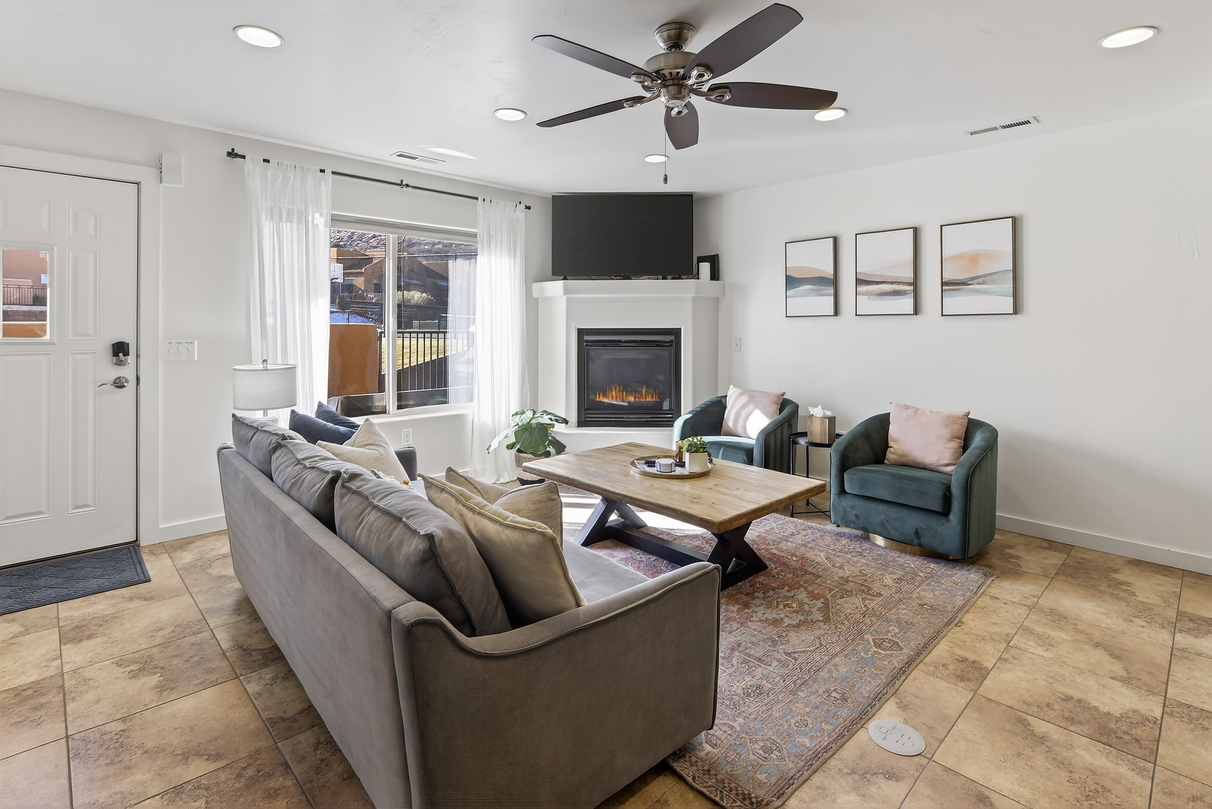 Living area featuring a fireplace with a white mantel, recessed lighting, and a ceiling fan