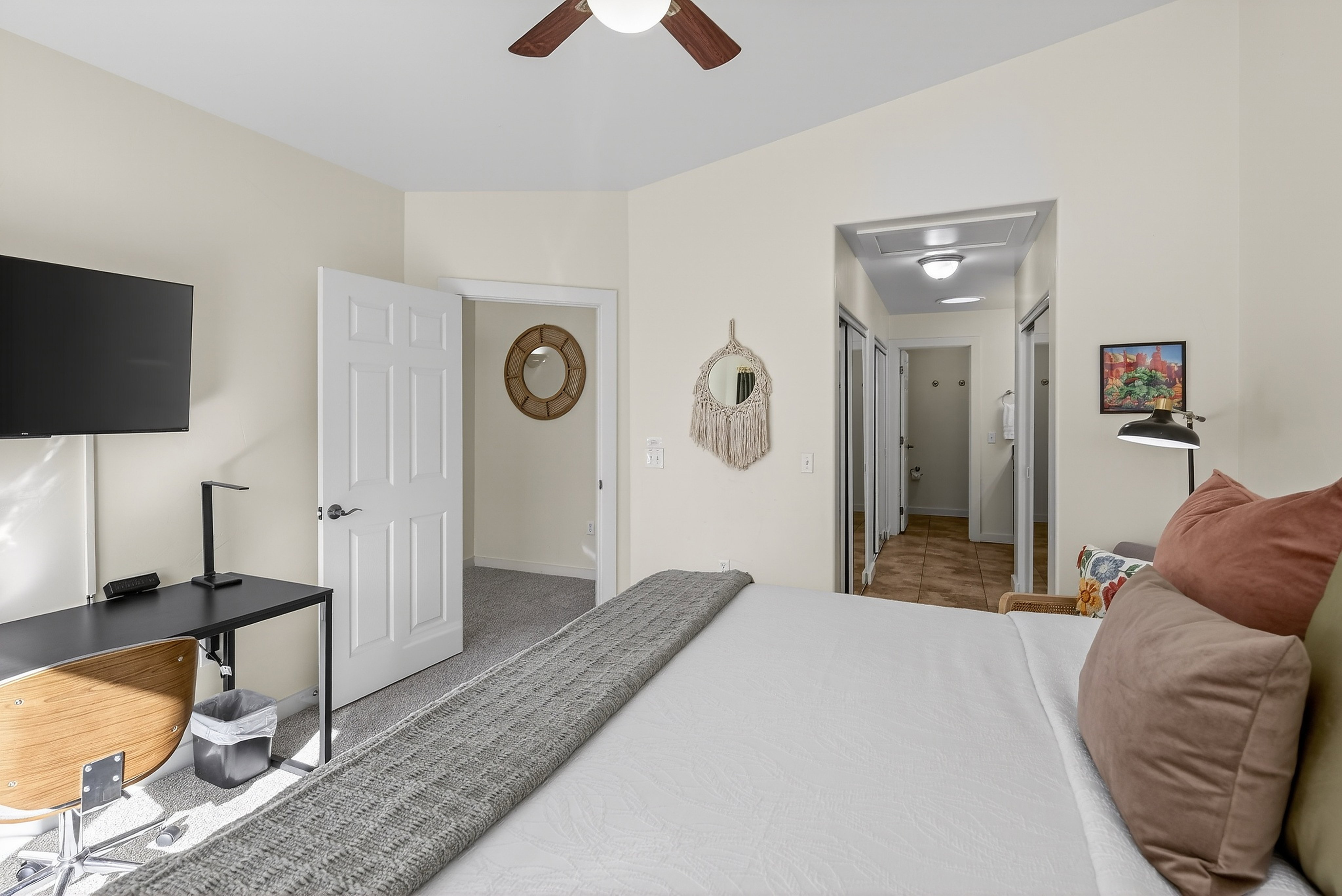 Interior room featuring a vaulted ceiling and a wood-finish ceiling fan