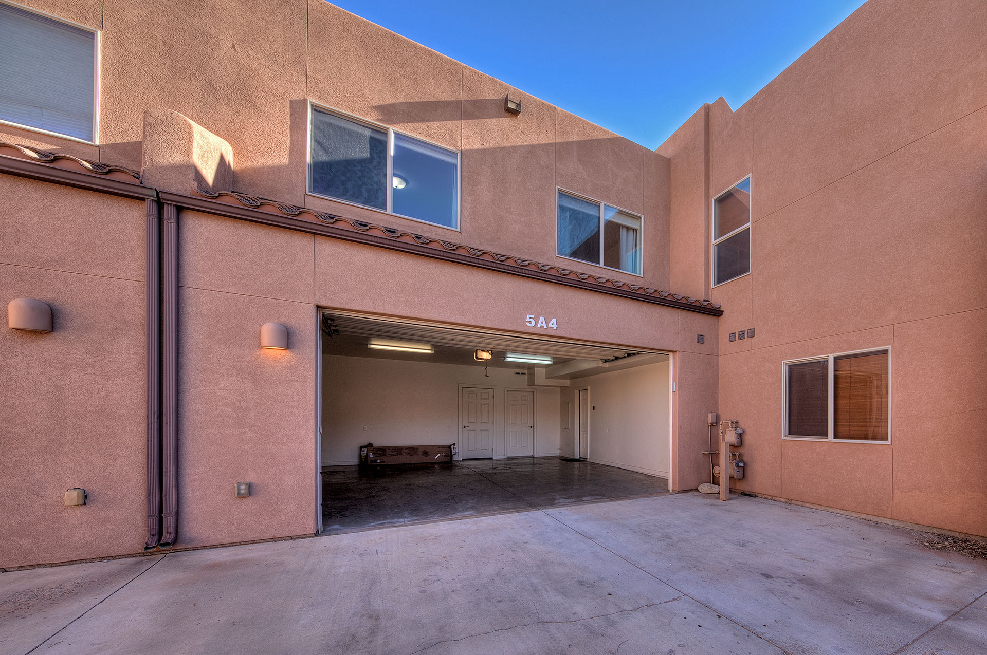 Exterior stucco finish, tile roof trim, and multi-pane windows