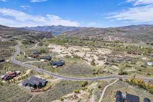 Expansive elevated lot featuring a winding paved road and natural landscape