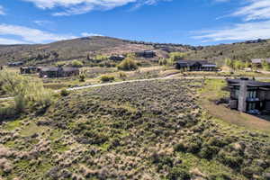 Expansive elevated lot featuring natural landscaping and mountain scenery