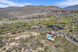 Expansive property featuring multiple structures, a swimming pool, and a pond