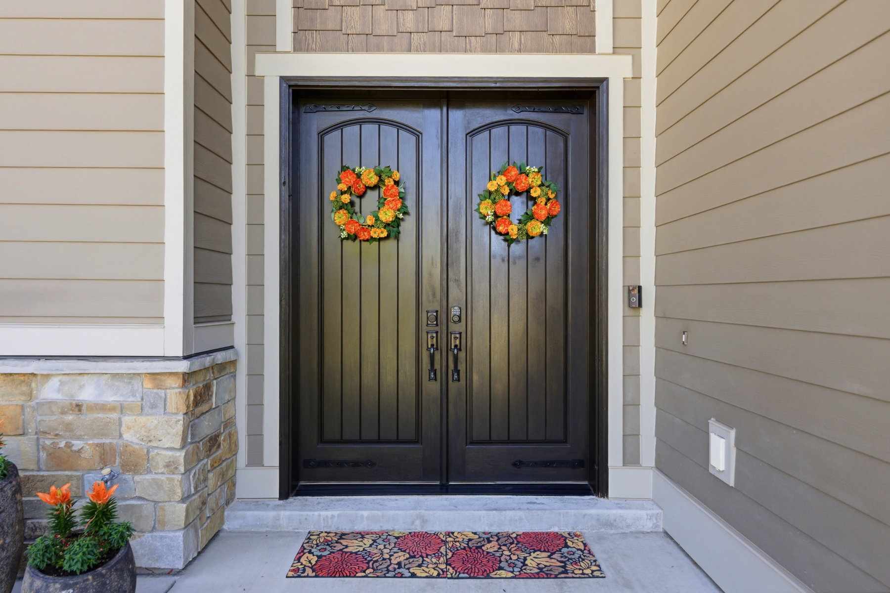 Double entry doors featuring dark wood-finish with arched top panels
