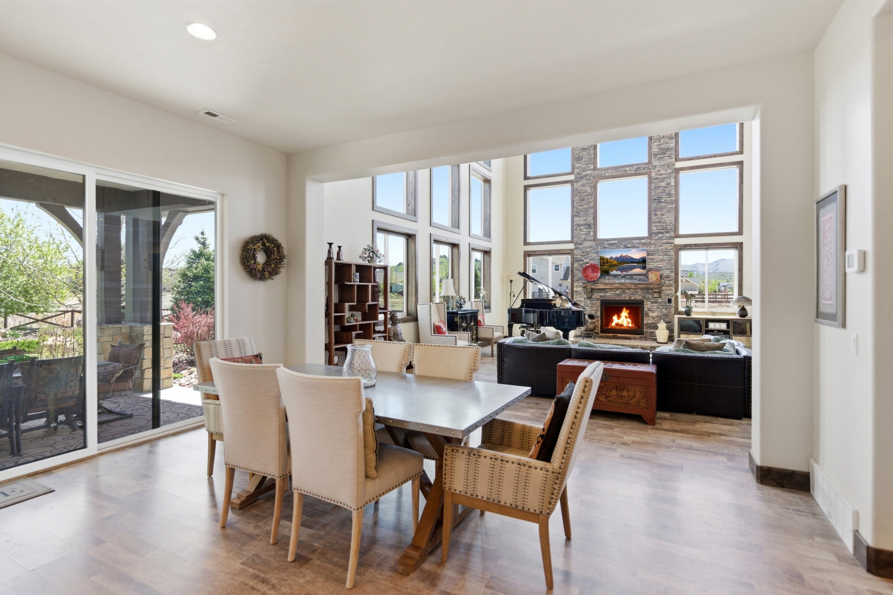 Spacious dining area with wood-finish flooring and direct access to an outdoor patio via sliding glass doors