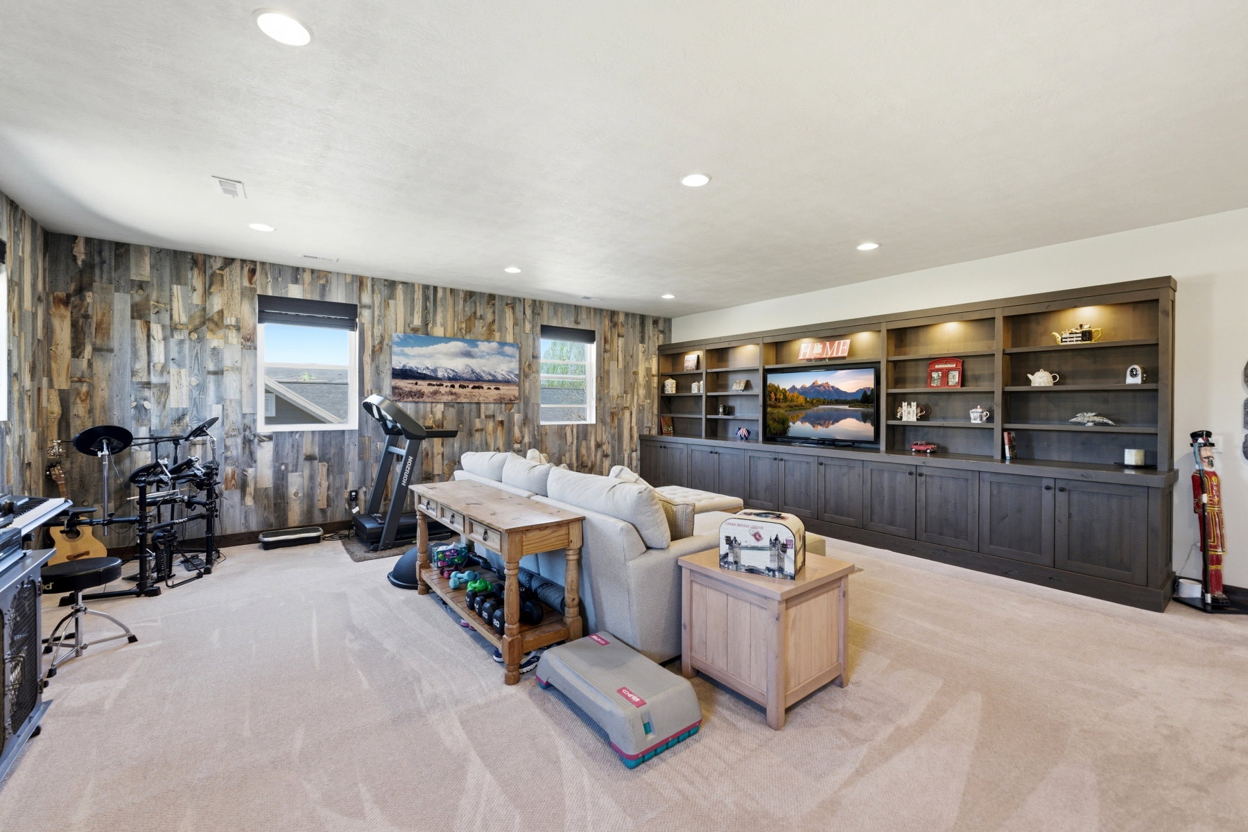 Reclaimed wood accent wall and custom built-in cabinetry featuring integrated lighting
