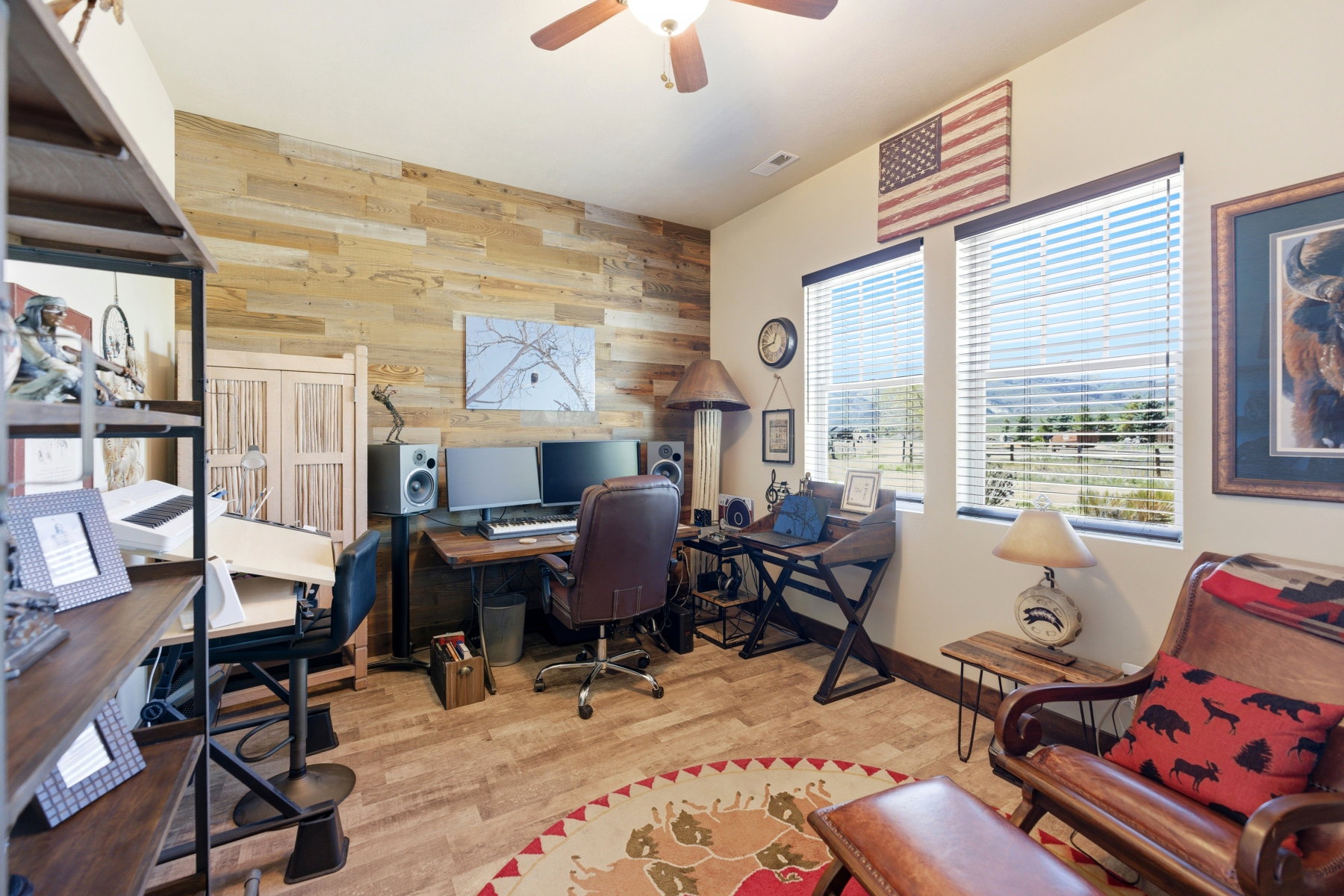 Office space featuring a wood-paneled accent wall and wood-finish flooring