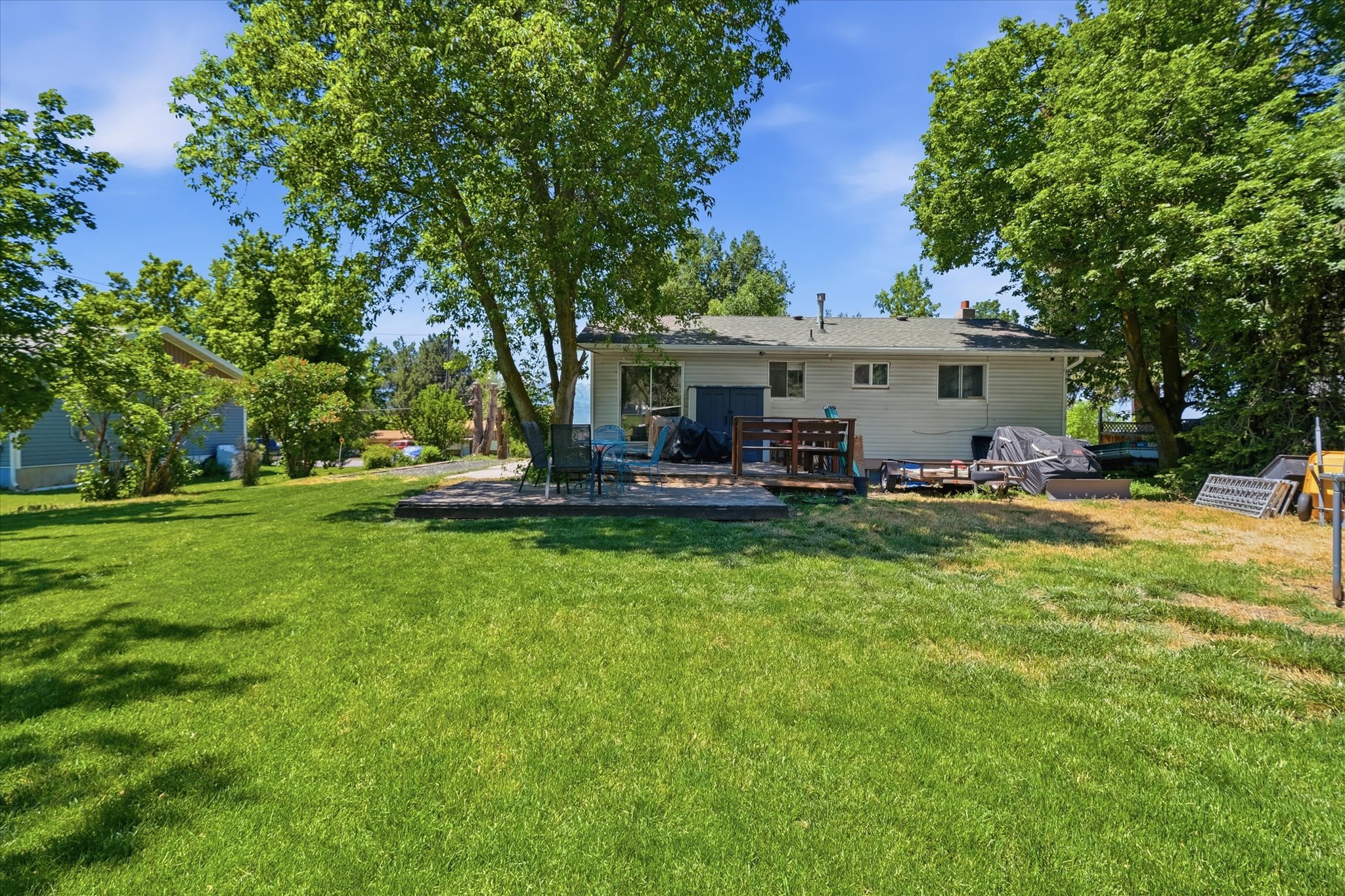 Expansive rear yard featuring mature trees and a substantial lawn area