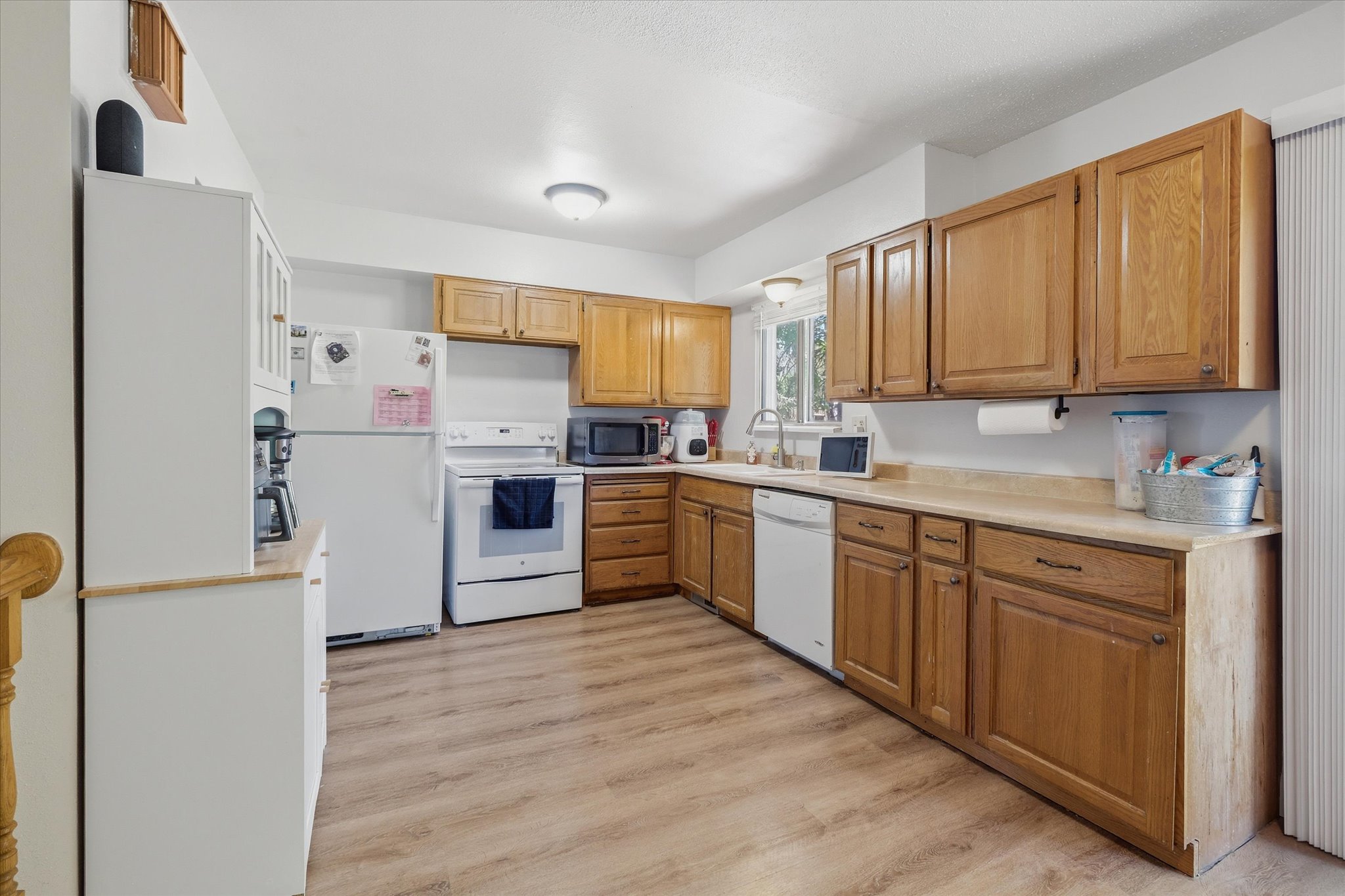 Kitchen featuring wood-finish flooring and light wood cabinetry