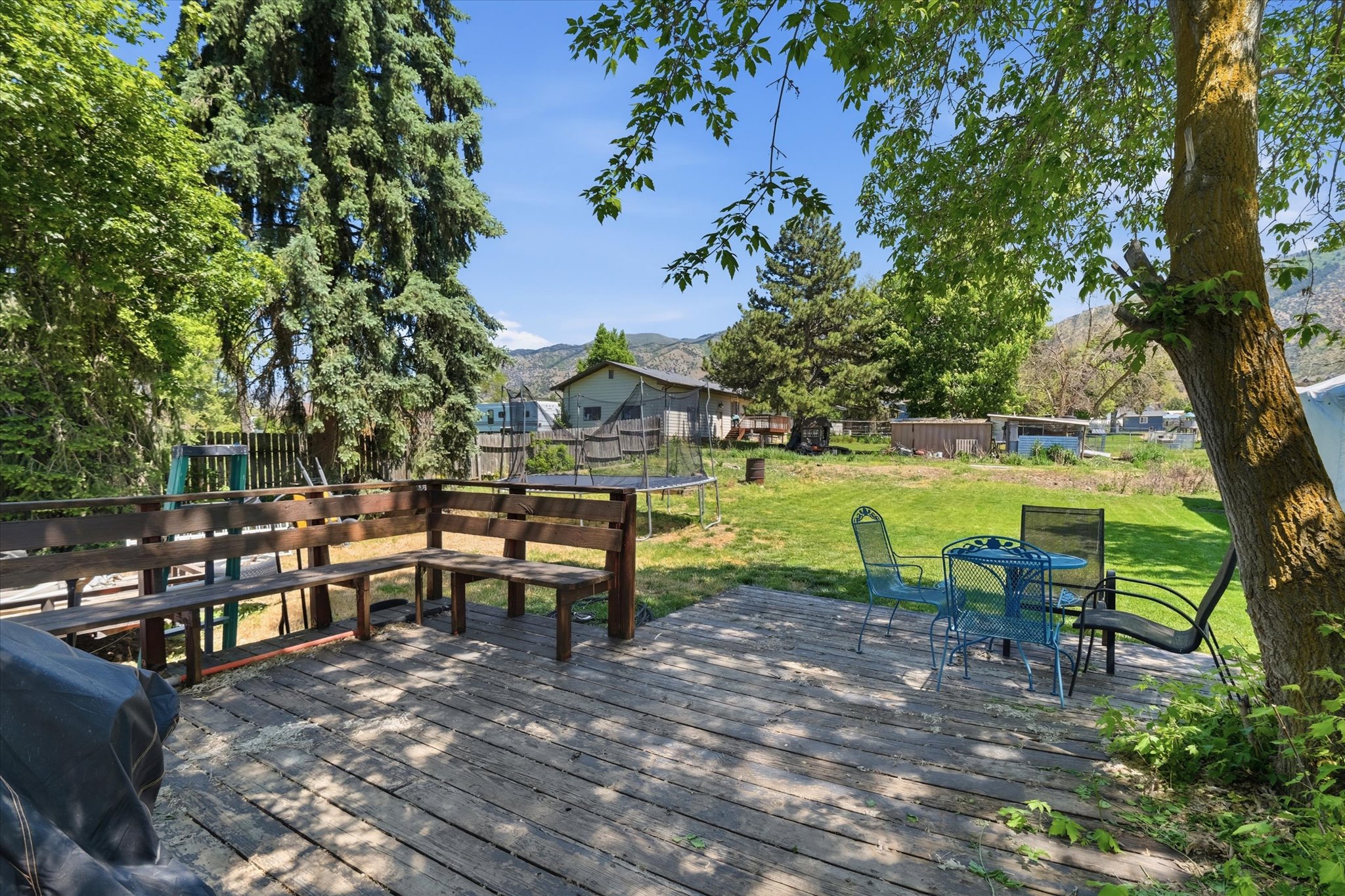Expansive wood-finish deck with built-in bench seating