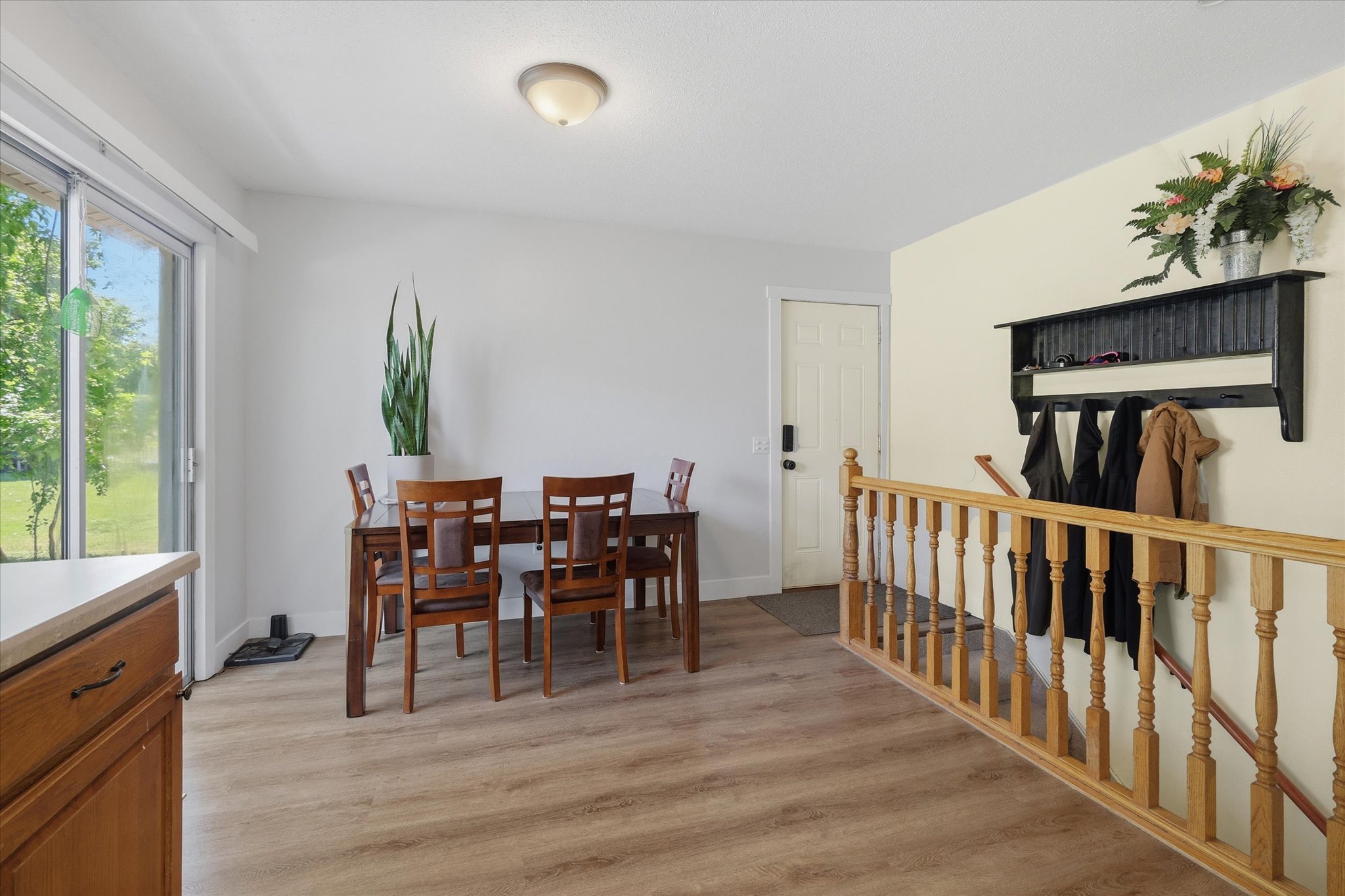 Open concept dining area with wood-finish flooring