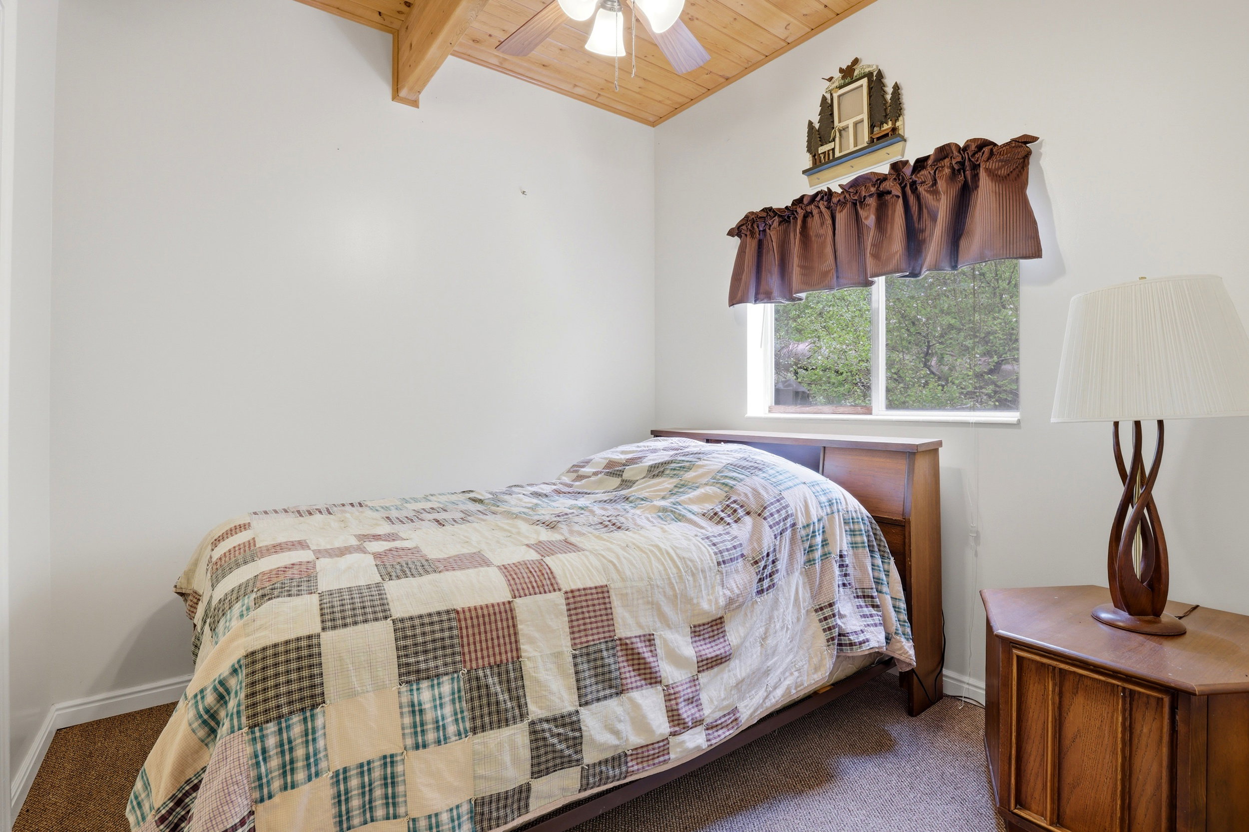 Vaulted wood-paneled ceiling with exposed beam