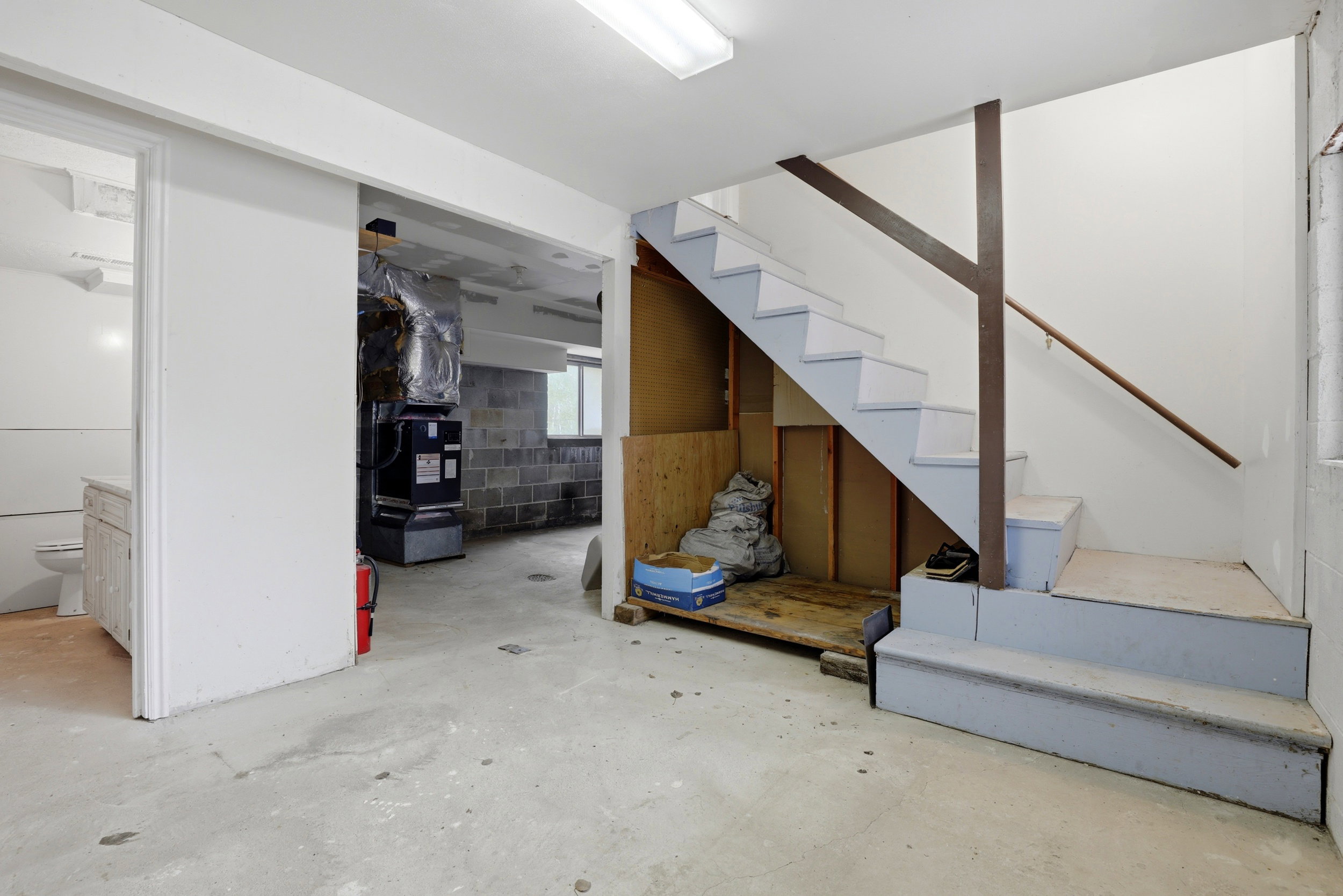 Staircase with painted treads and risers, featuring a wood handrail
