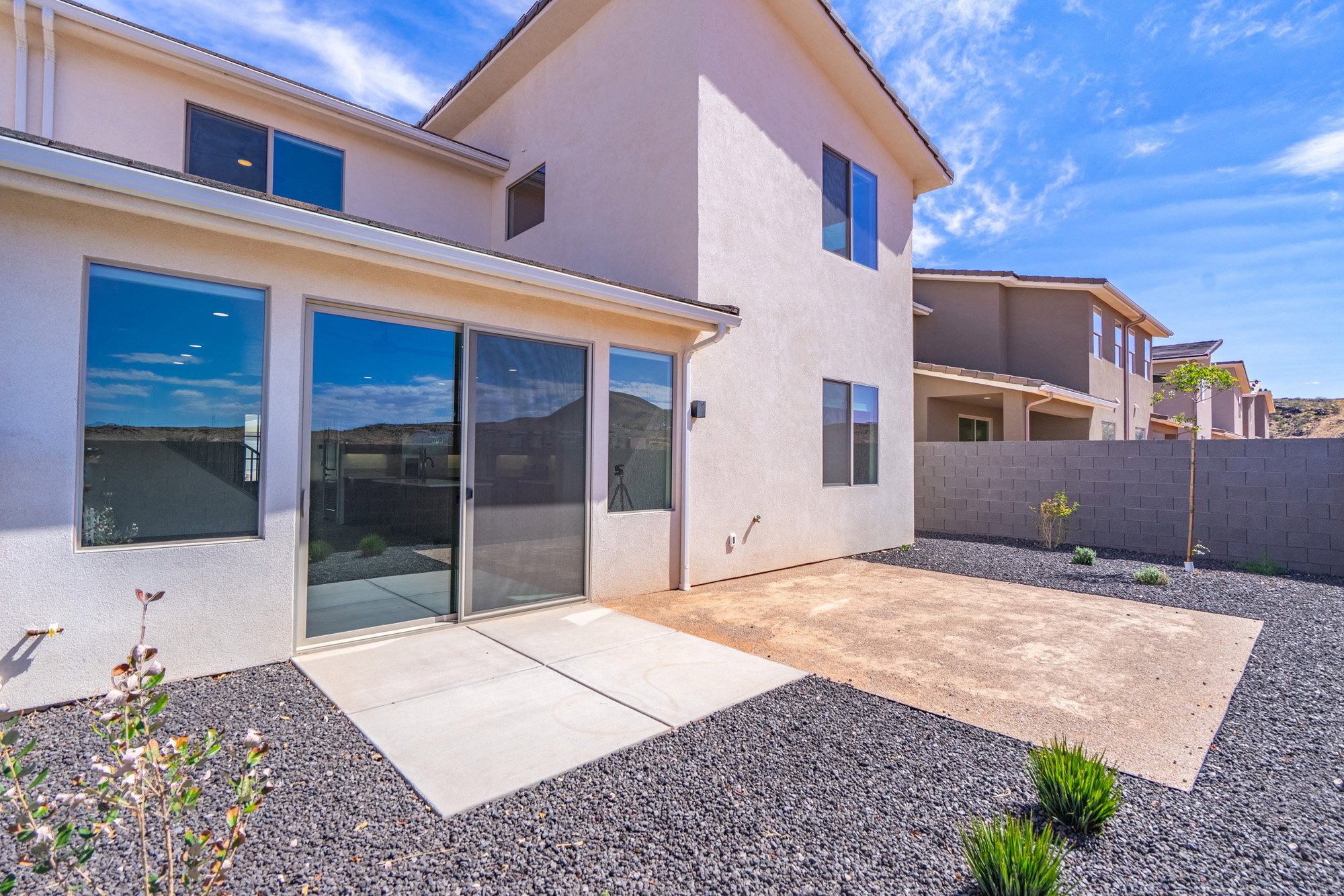 Rear exterior featuring a patio with concrete and gravel groundcover