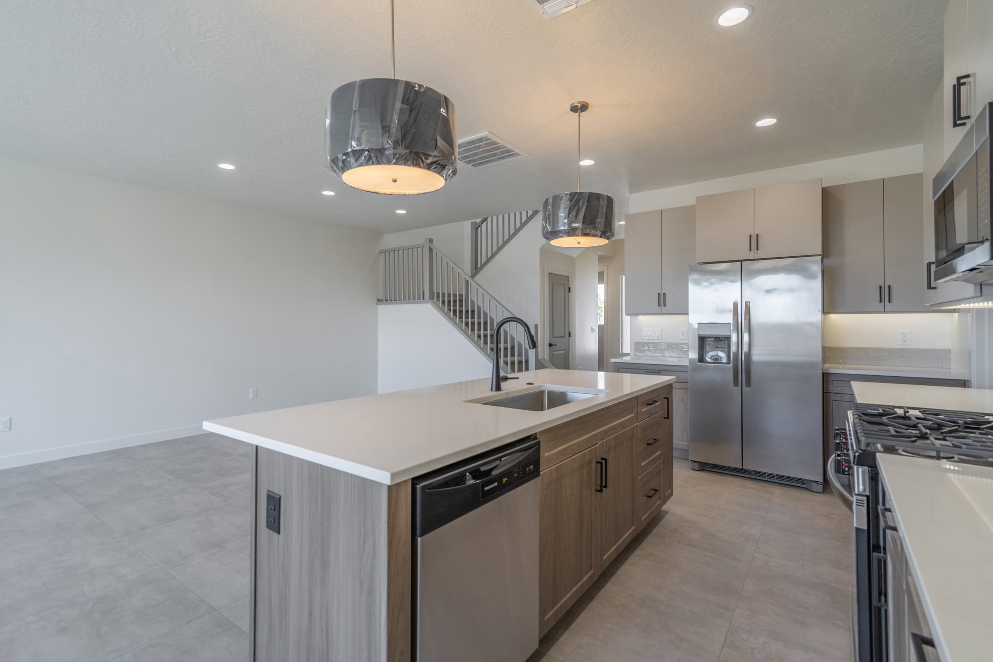 Modern kitchen featuring a large island with an undermount sink and integrated dishwasher