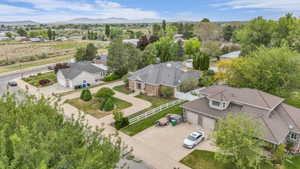 Aerial perspective showcasing multiple properties with mature trees and a distant mountain range