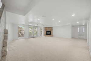 Spacious interior with neutral carpeting and recessed lighting