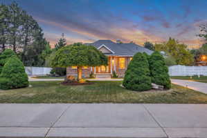 Ranch-style residence featuring a prominent front entrance and a dark-toned roof
