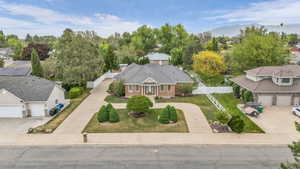 Traditional brick residence with a columned front entry, a circular driveway, and a well-manicured front lawn