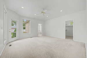 Spacious room with plush carpet flooring, recessed lighting, and a ceiling fan