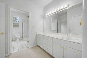 Double vanity with white cabinetry and gold-tone hardware