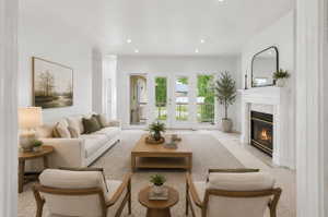 Virtually Staged-Bright living room featuring a decorative fireplace with a white mantel, recessed lighting, and French doors