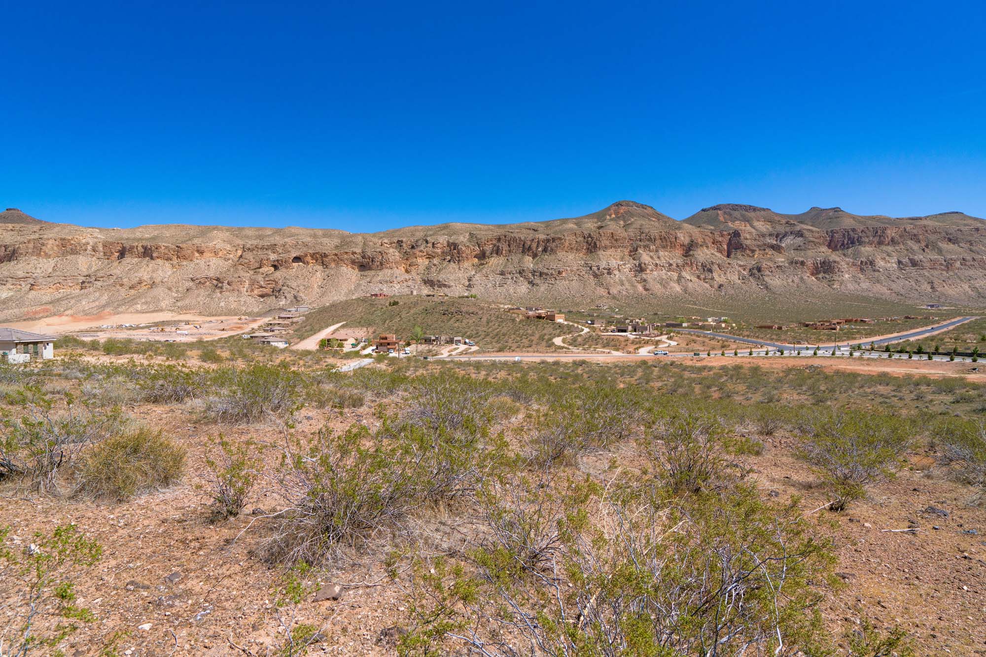 Expansive desert landscape with natural vegetation and distant mountain ranges