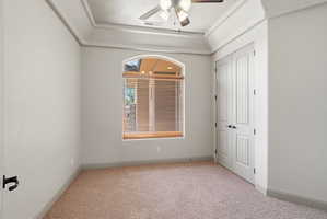 Bedroom 1: Arched window featuring wood-finish blinds