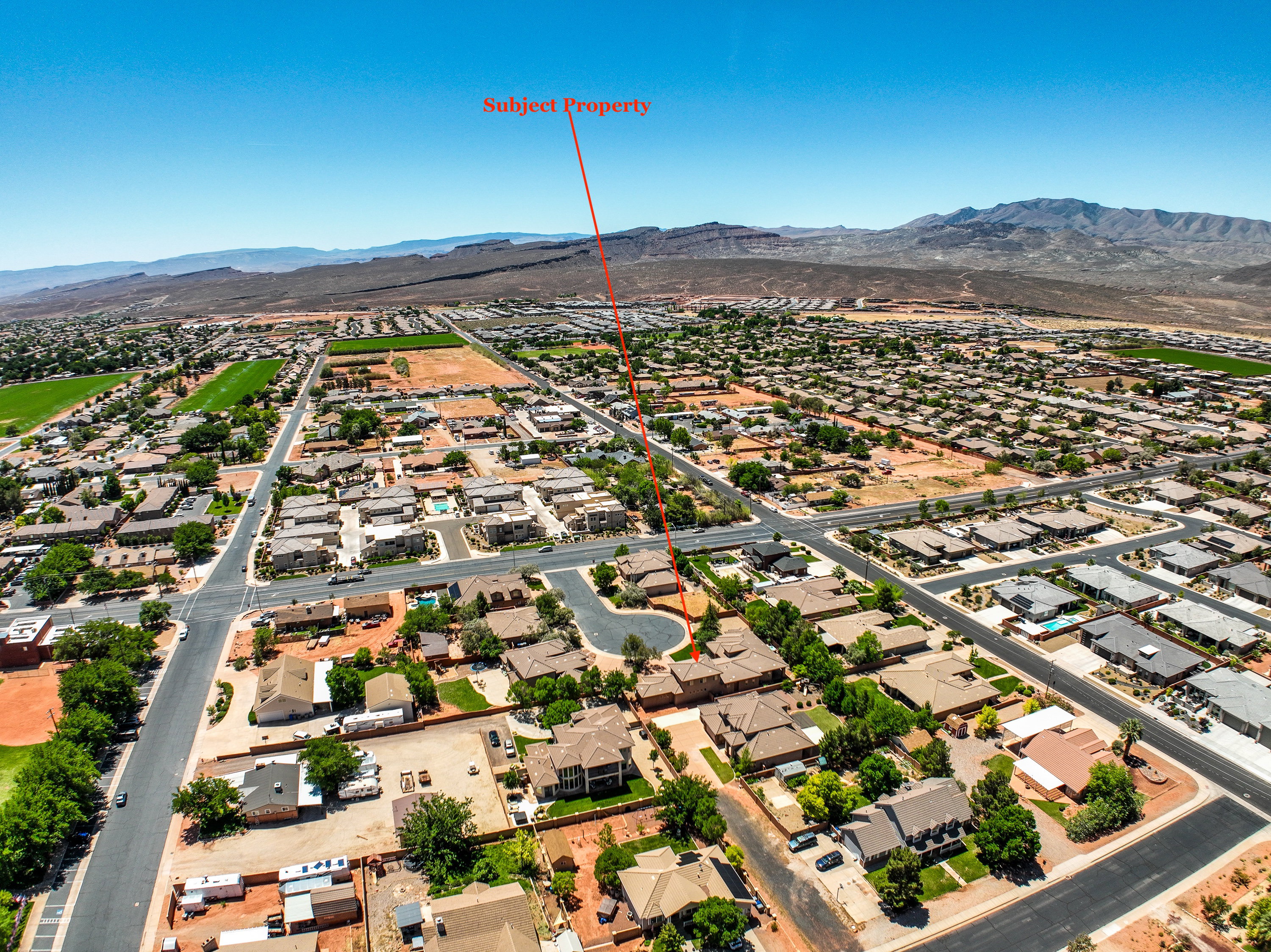 Aerial perspective showcasing the residential neighborhood with a distant mountain range backdrop.