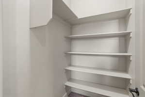 Large linen closet with multiple white shelving units