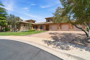 Stucco exterior with stone accents and a terracotta tile roof