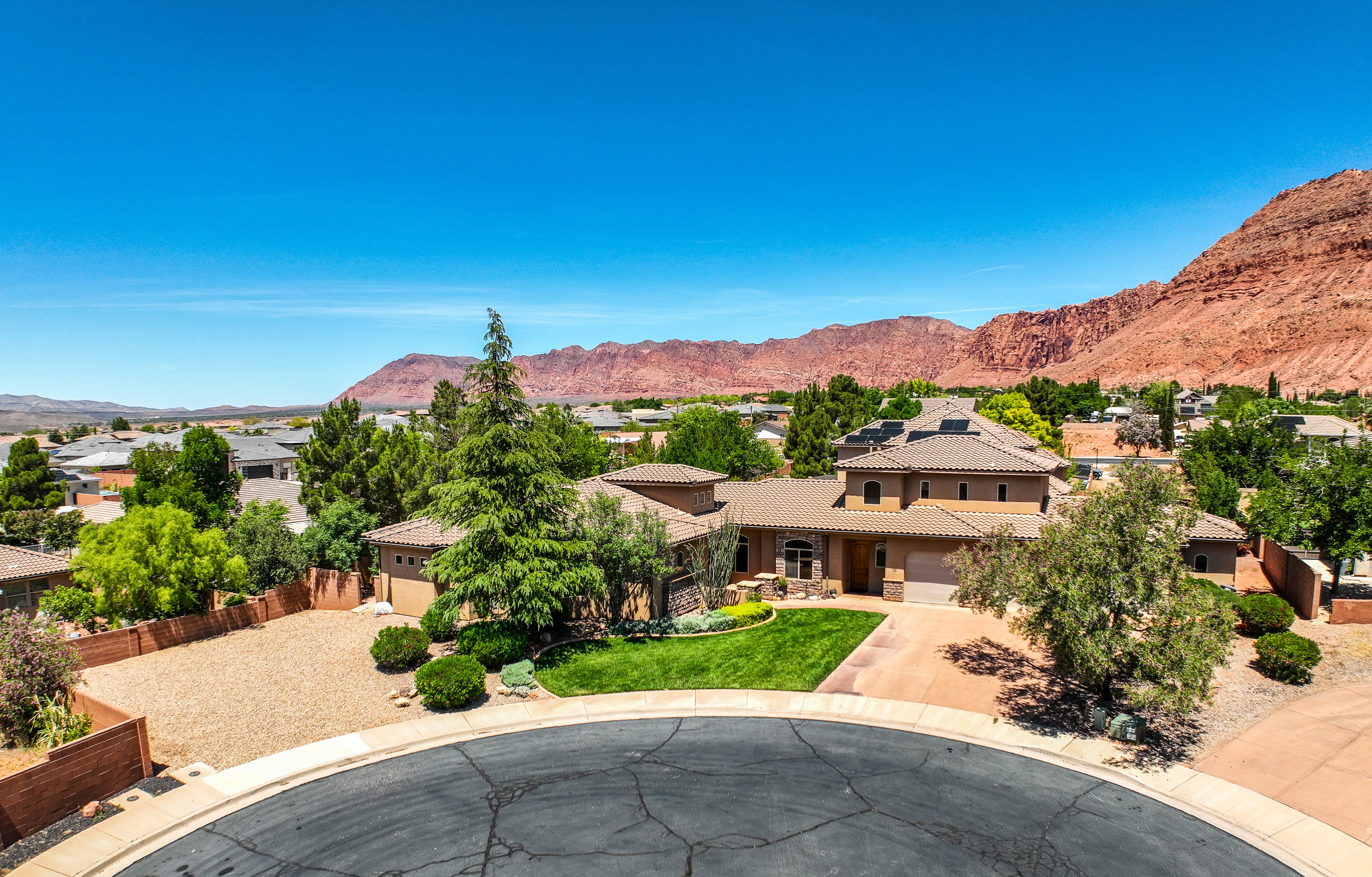 Aerial view of contemporary stucco exterior with a tile roof and integrated garage.