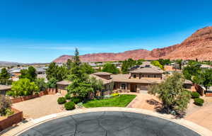 Aerial view of contemporary stucco exterior with a tile roof and integrated garage.