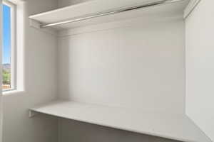 ADU closet with a single window, upper shelf, and lower shelf