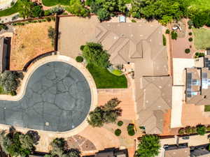 Aerial view showcasing a residential property with a multi-gabled roofline.