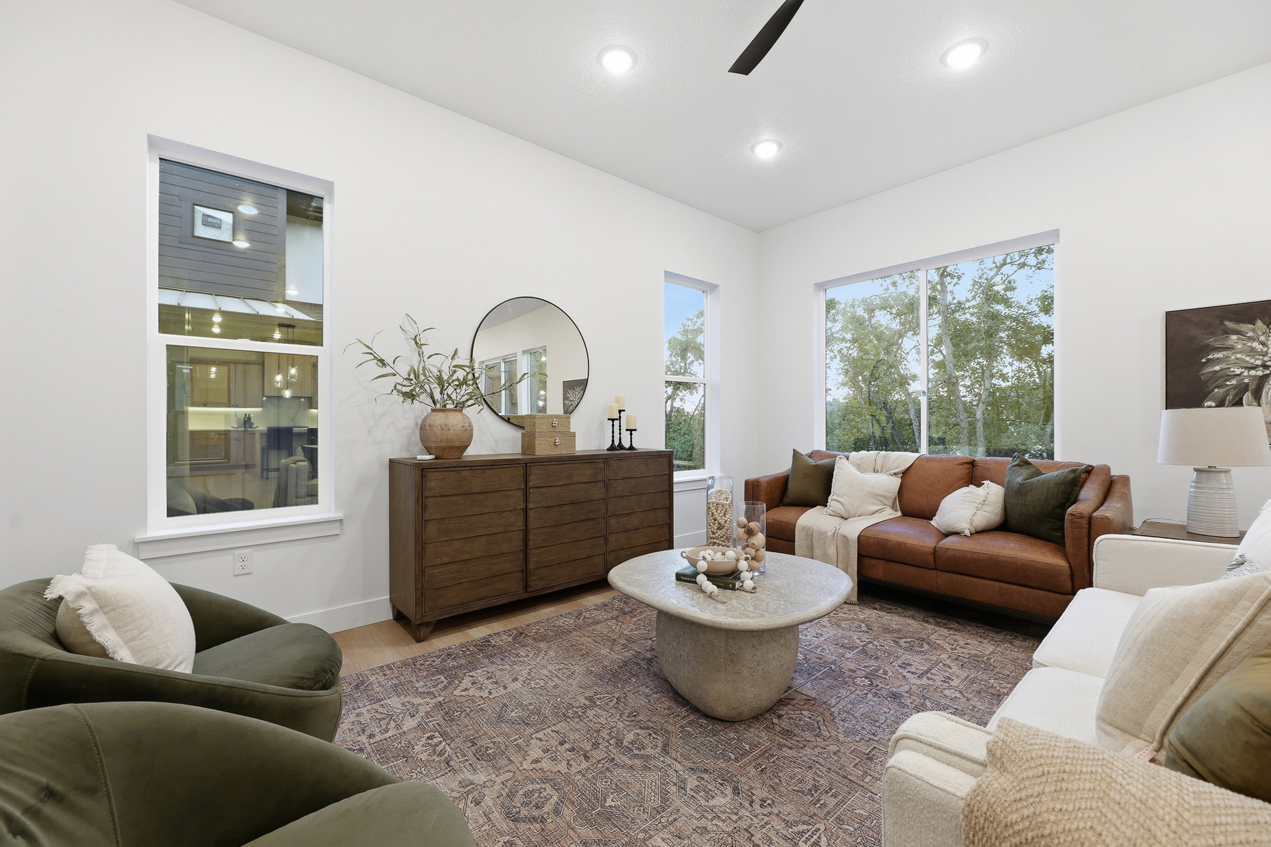 Bright living space featuring recessed lighting and a ceiling fan