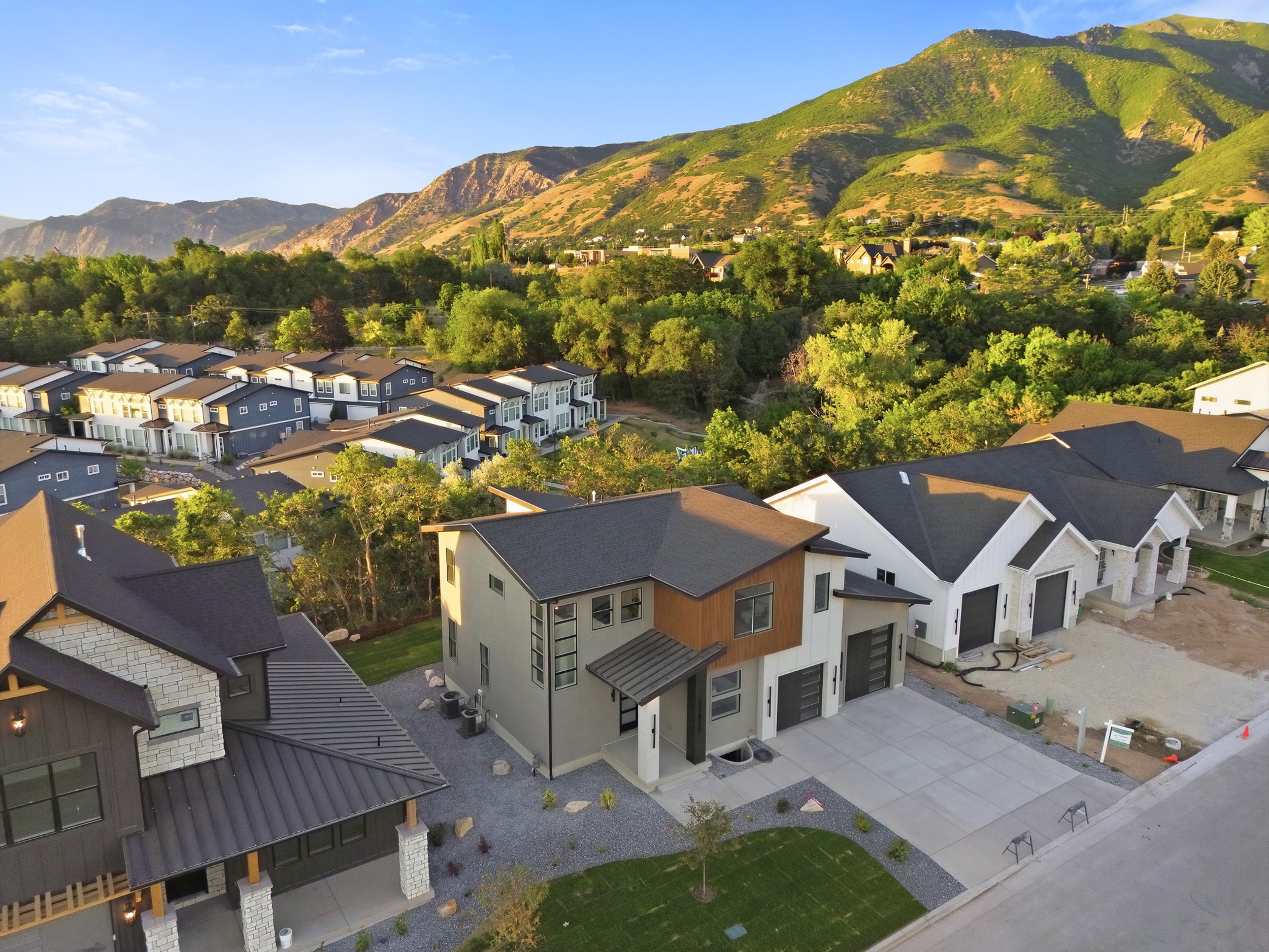 Modern architectural residence featuring a two-car garage, concrete driveway, and a combination of smooth and textured exterior finishes