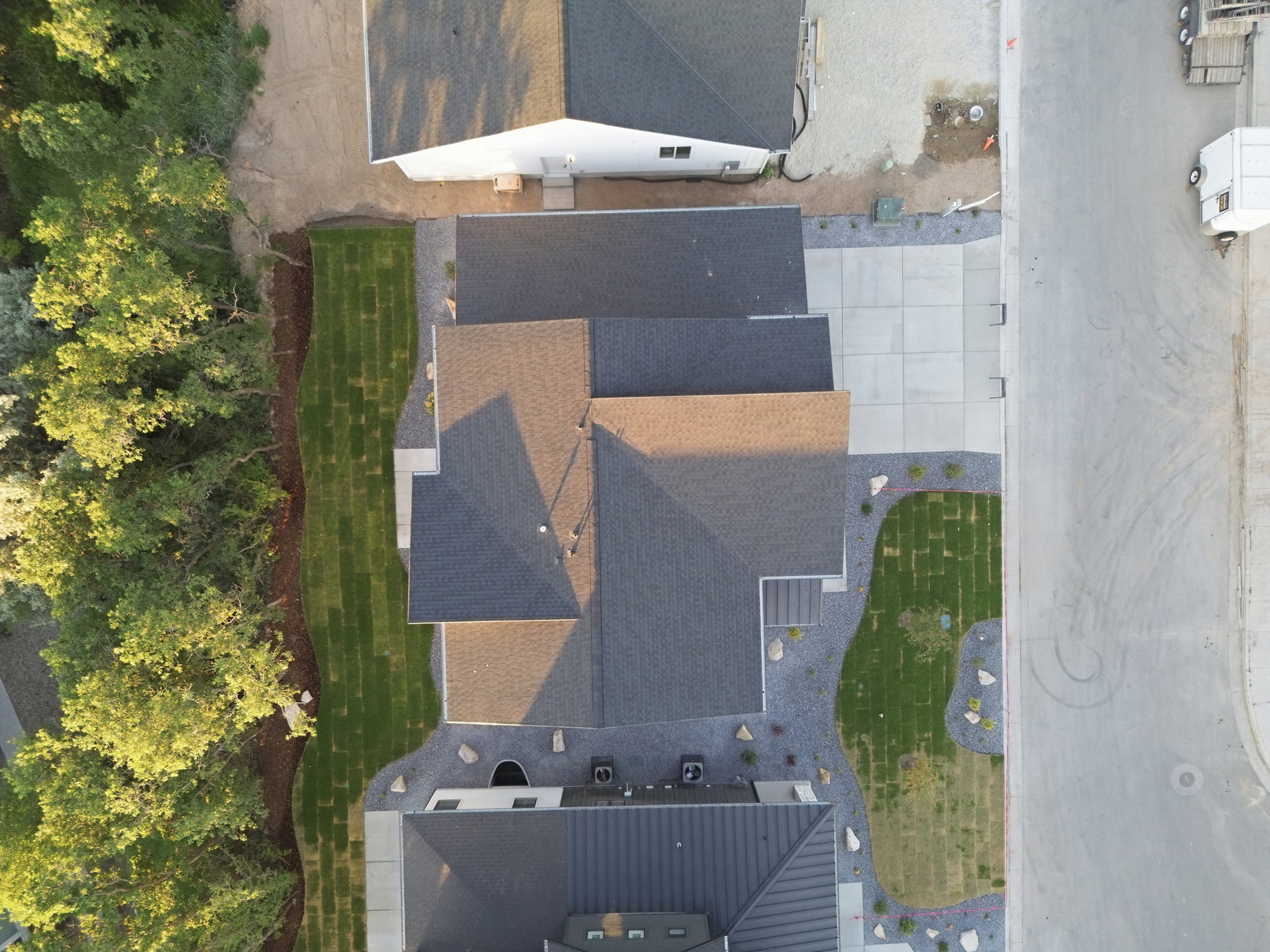 Newly laid sod and gravel landscaping frame the property