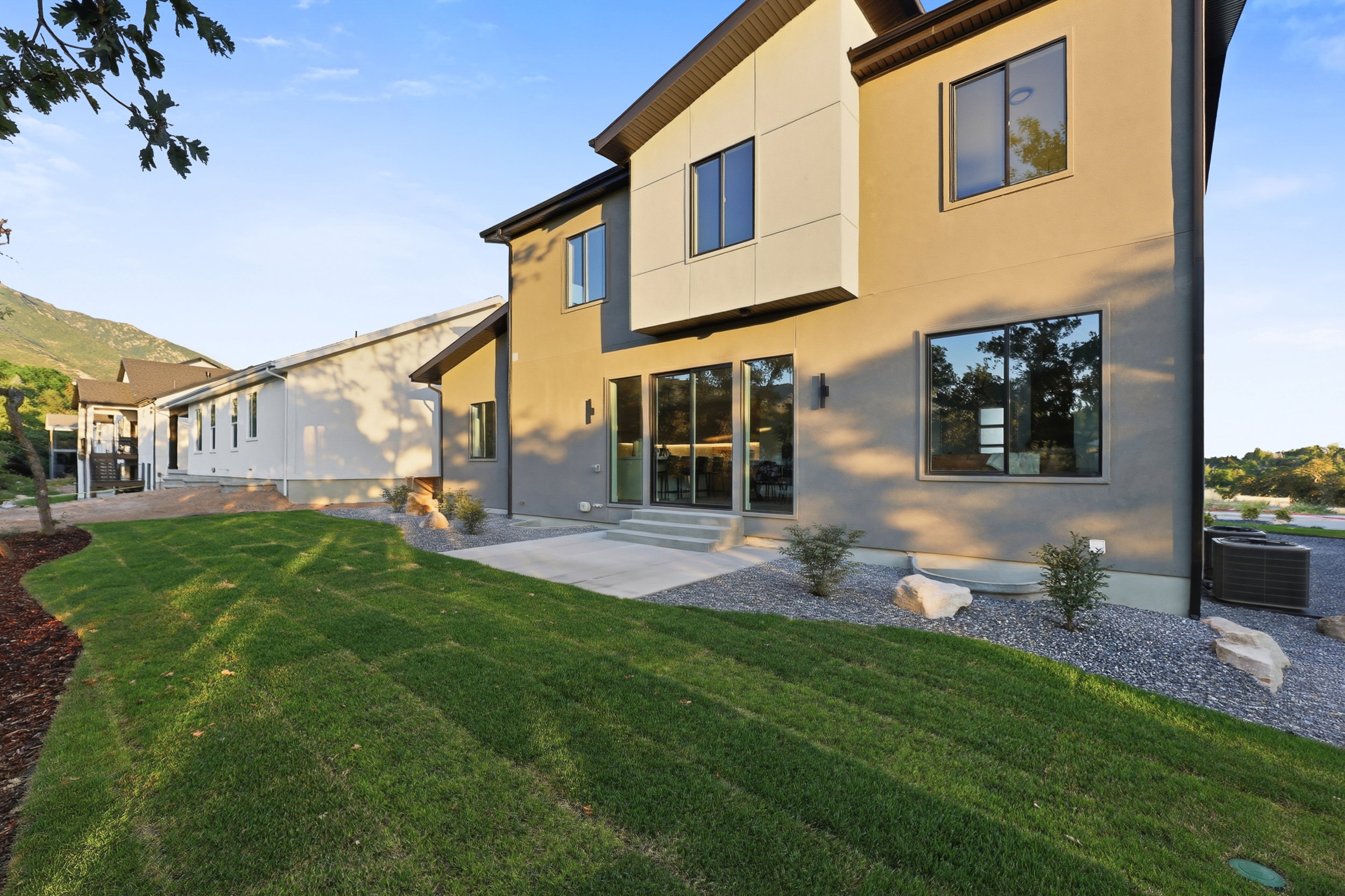 Expansive green lawn with a concrete patio